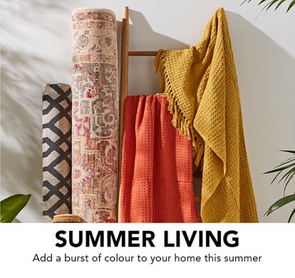 A collection of rugs, blankets and runners draped over a stand.